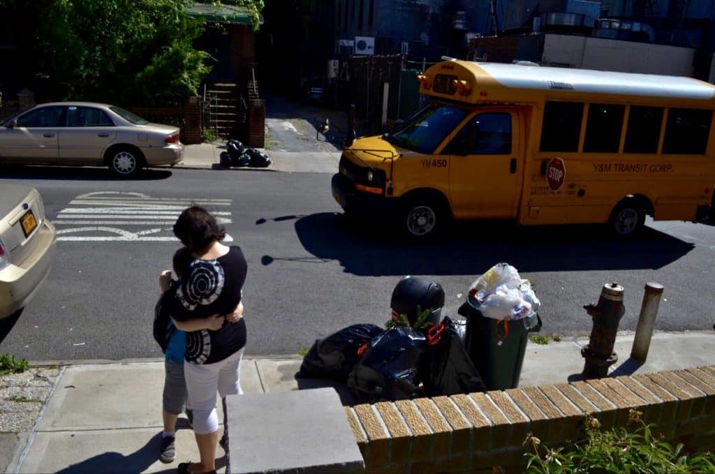 Mompreneur putting down her work and welcoming her son home from school.