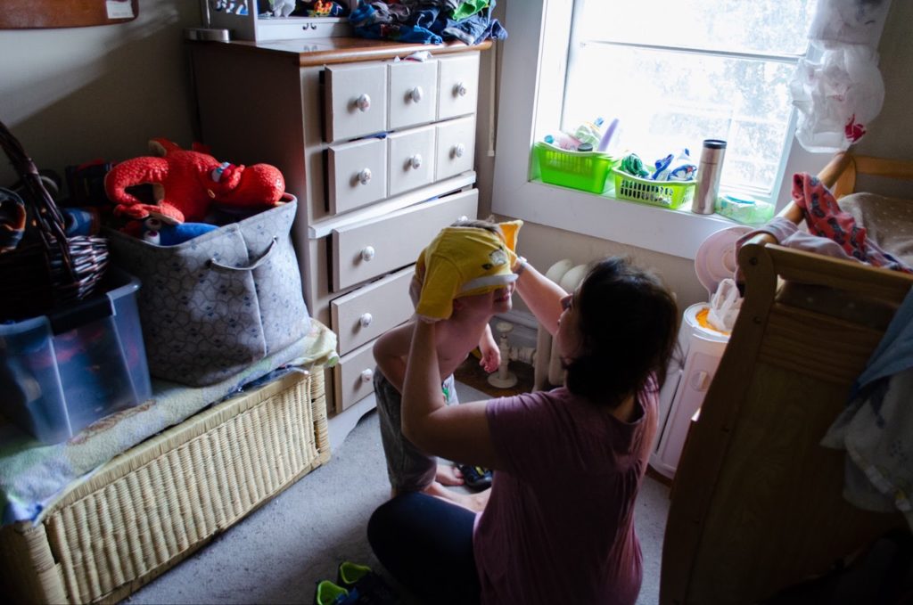 Mompreneur gets her son dressed for school.